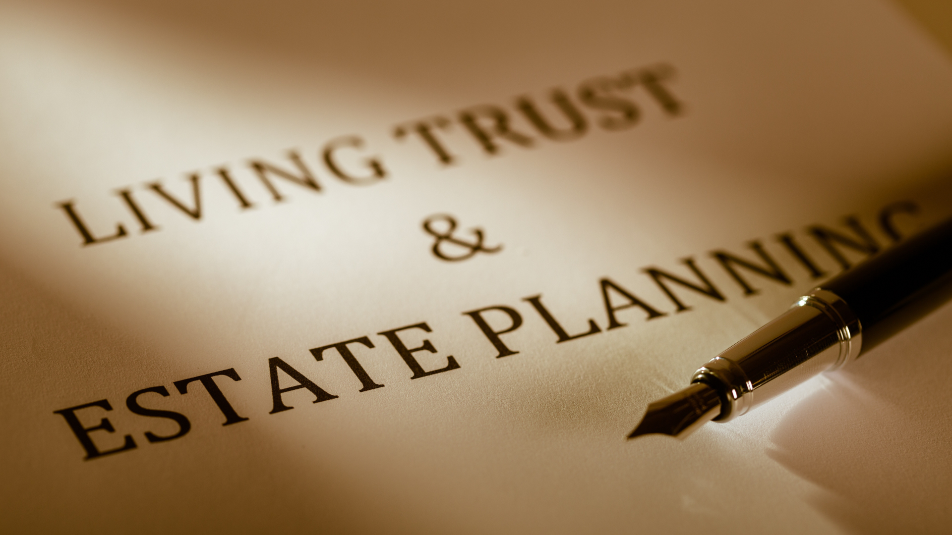 A sheet of paper with a fountain tipped pen and the words Living Trust & Estate Planning written on it to introduce a blog on the basics of estate planning.